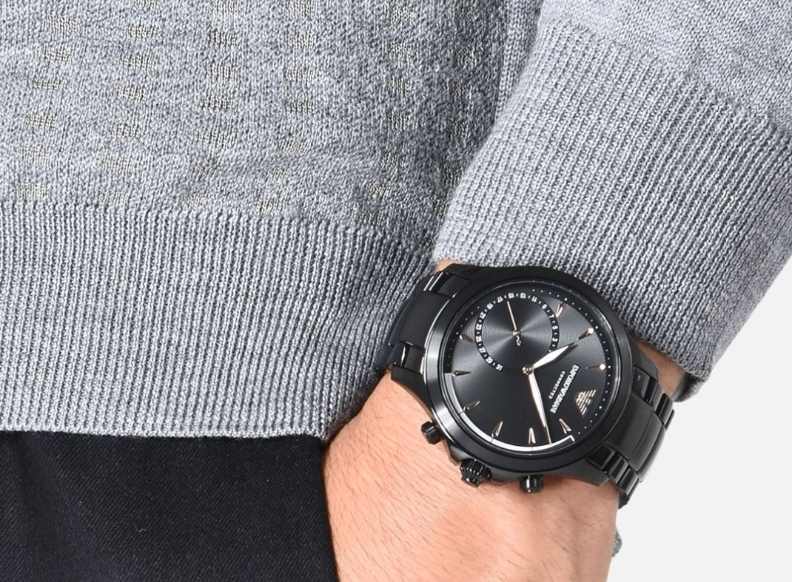 Mann trägt Emporio Armani Connected Hybrid Smartwatch am Handgelenk Hand in Hosentasche Mann trägt Emporio Armani Connected Hybrid Smartwatch am Handgelenk Hand in Hosentasche
