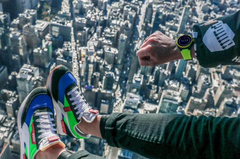 Mann mit Puma Smartwatch am Handgelenk über Skyline Mann mit Puma Smartwatch am Handgelenk über Skyline